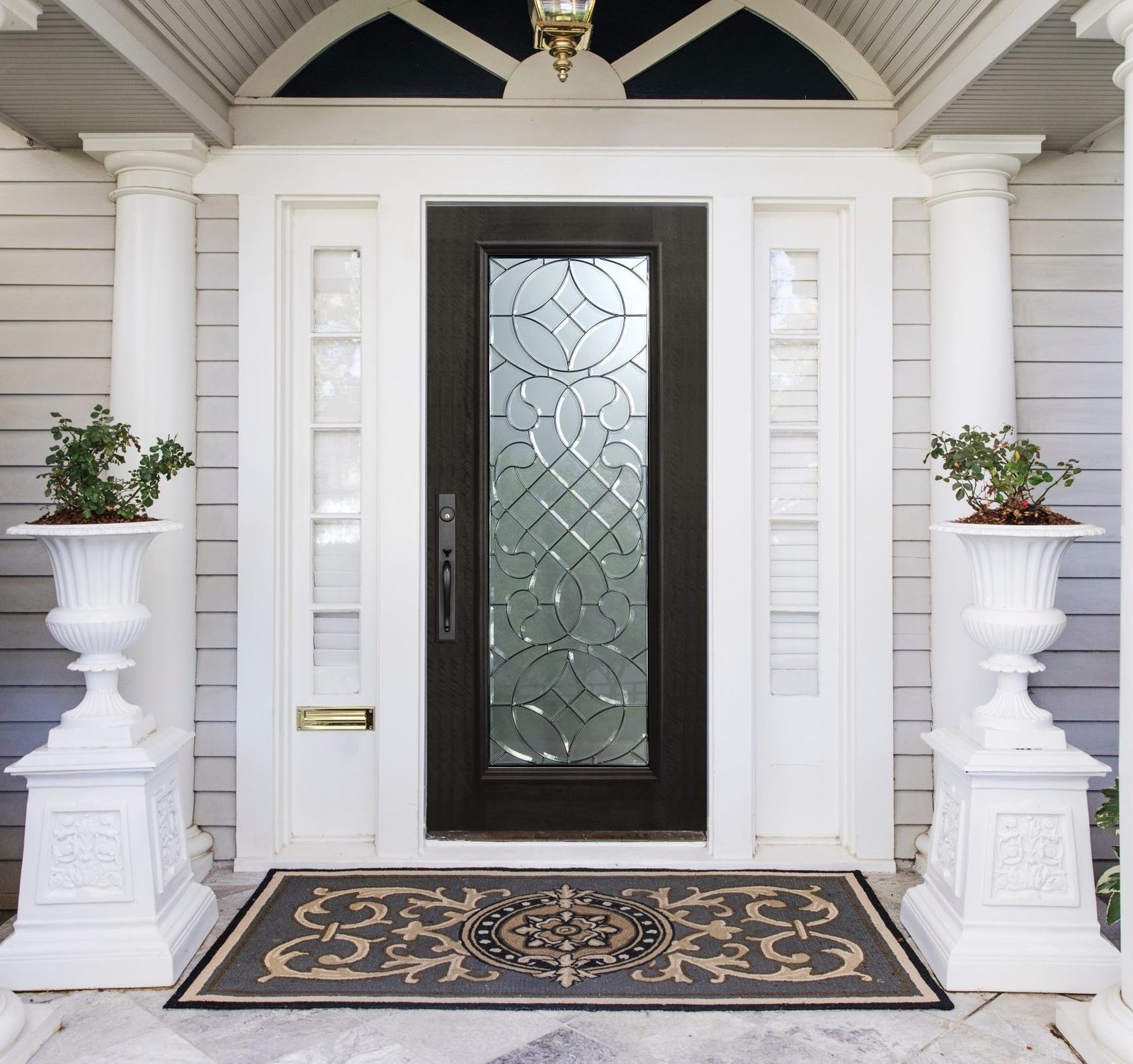 a wood entry door with white frame arch