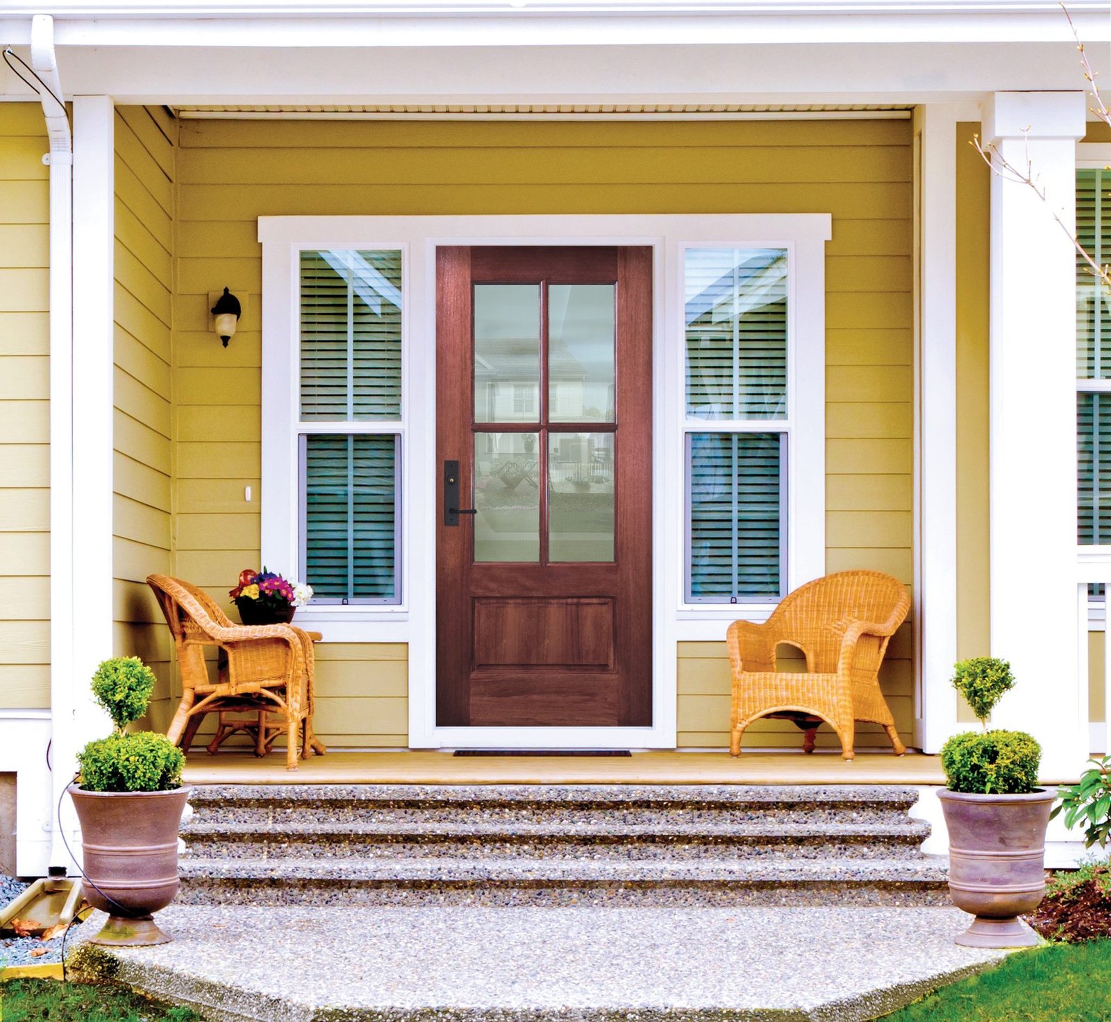 yellow house with true divided light wood door
