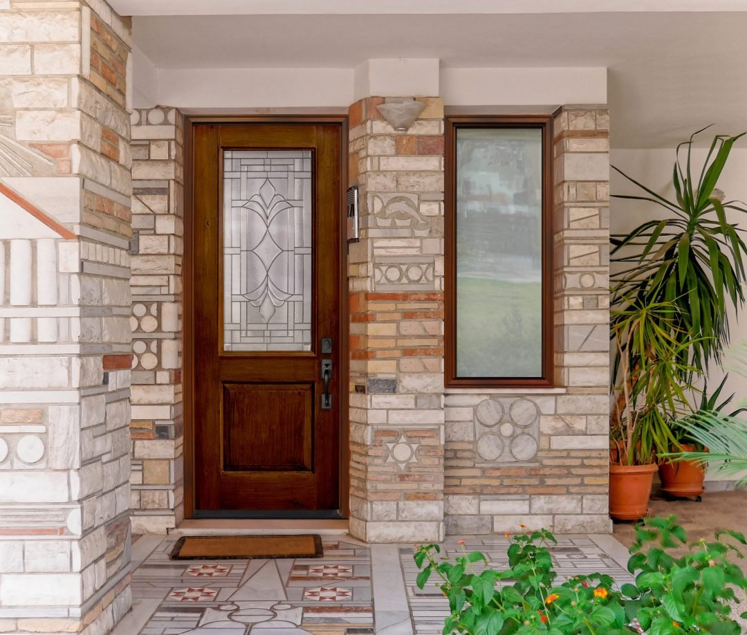 contemporary house entrance with natural wood door and stone covered wall, Athens Greece