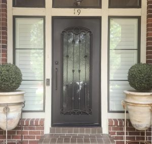 red brick home with iron entry door